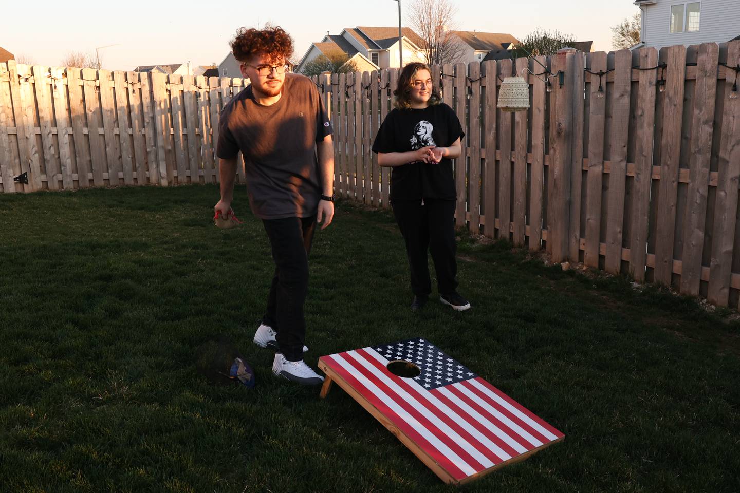 Nicholas Reyes plays a game of bags with his sister, Lizzie, in their backyard on Wednesday, April 12, 2023 in Joliet. Nicholas was recently diagnosed with the same rare kidney syndrome as his sister.