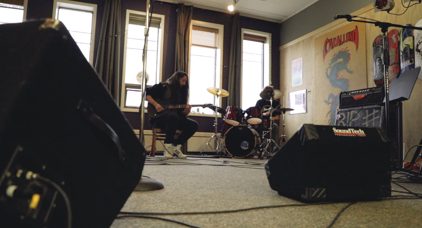 Clay Mutert teaching music lessons at Warp Corps in Woodstock.