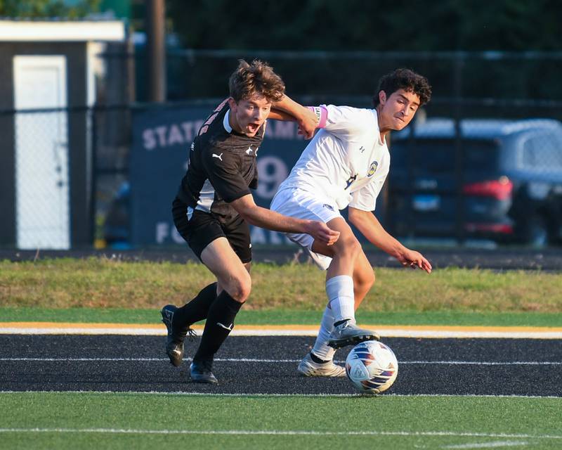 Wheaton Warrenville South's Jay Weber, left, battles for the ball against Wheaton North's Michael Shebar during the game on Thursday Sept. 11, 2025, held at Wheaton Warrenville South High School.
