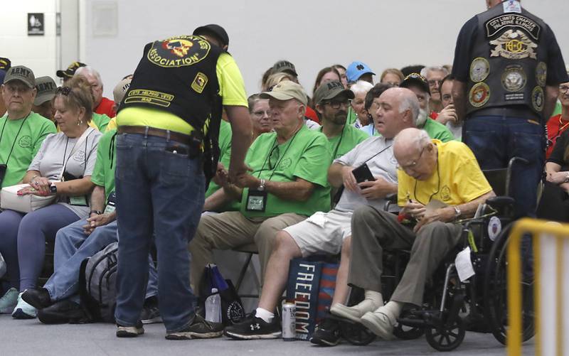 Veteran Anthony “Cowboy” Diller from the Combat Veterans Motorcycle Association, hands out mission beads to veterans who returned  from an Honor Flight trip to Washington D.C., on Sunday, Aug. 27, 2023.