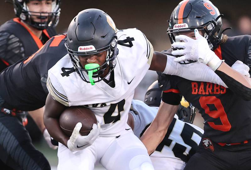 Sycamore's Tyler Curtis holds off DeKalb's Landon Simonson during the First National Challenge Friday, Aug. 26, 2022, in Huskie Stadium at Northern Illinois University in DeKalb.