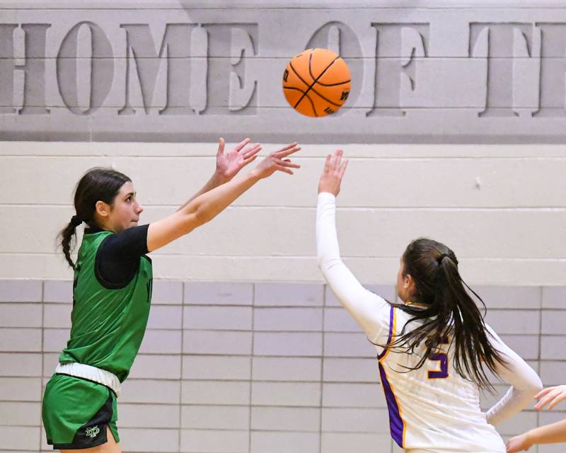 York's Anna Filosa, left, makes a three point shot while being defended by Downers Grove North's Campbell Thulin (5) during the game on Tuesday Dec. 3, 2024, held at Downers Grove North High School.