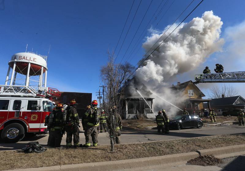 Heavy smoke billows from the roof of a fully engulfed house fire in the 800 block of Bucklin Street on Friday, Jan. 23, 2026 in La Salle.
