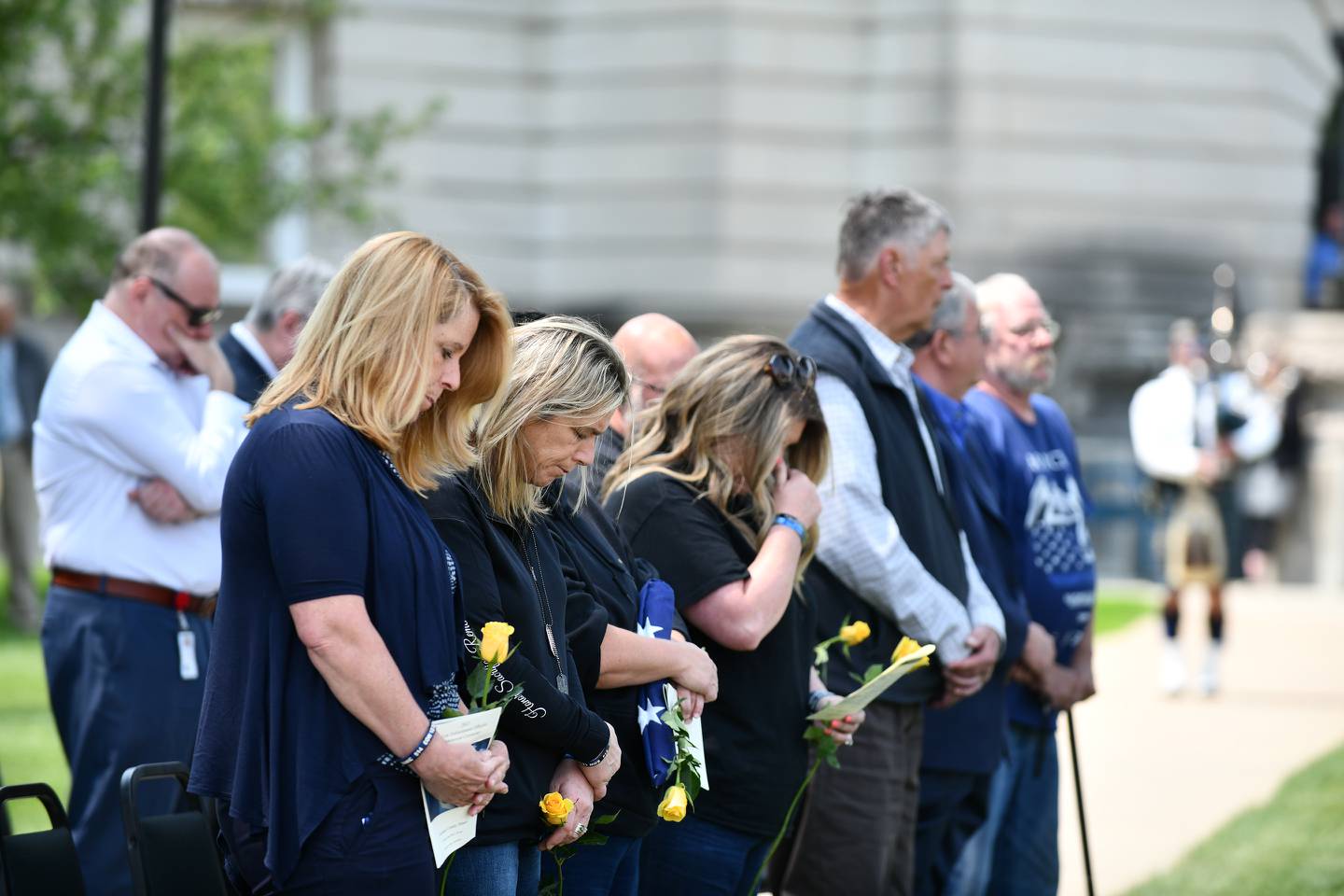 Family of fallen Bradley Police Sgt. Marlene Rittmanic, from left, Kathleen Rittmanic-Emme, Lyn Stua-Rittmanic and Jennifer Johnson Whitaker, bow their heads as they listen to the bagpipes perform 'Amazing Grace' on Thursday, May 18, 2023, during the Law Enforcement Officers Memorial Ceremony at the Kankakee County Courthouse.