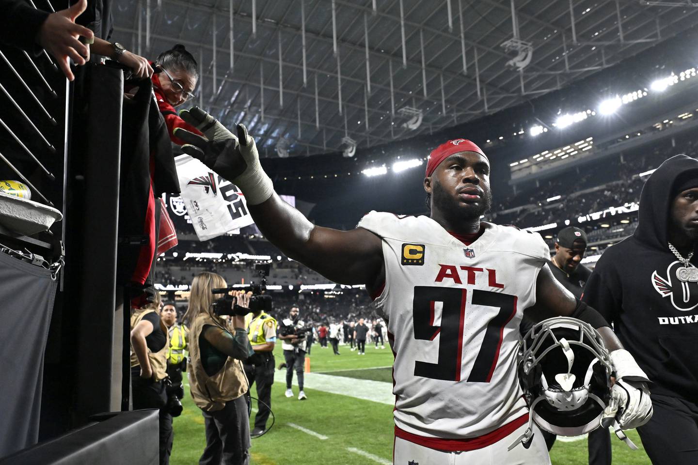 Atlanta Falcons defensive end Grady Jarrett (97) greets fans after an NFL football game against the Las Vegas Raiders, Monday, Dec. 16, 2024, in Las Vegas. (AP Photo/David Becker)