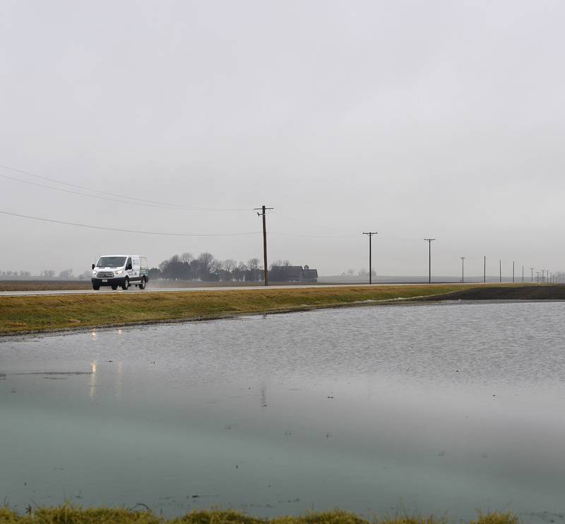 Flooded farm field as traffic goes by Tuesday, Feb. 22, 2022, on North 2150th Road near Grand Ridge.