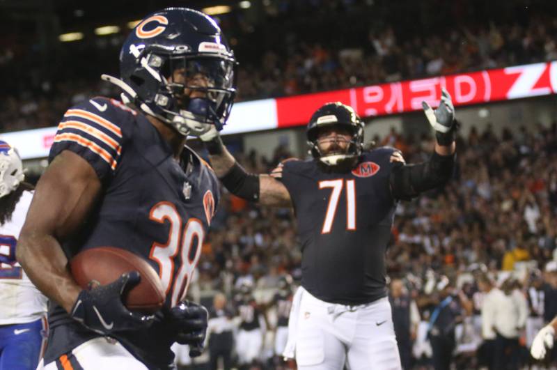 Chicago Bears running back Brittan Brown, scores a touchdown as teammate offensive lineman Ryan Bates, reacts on Sunday, Aug. 17, 2025 at Soldier Field in Chicago.
