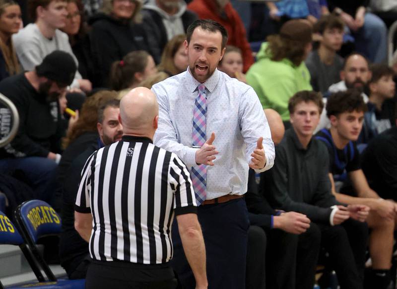 Hinckley-Big Rock head coach Seth Sanderson has a conversation with a referee during their game with Aurora Christian Friday, March 7, 2025, at Somonauk High School.