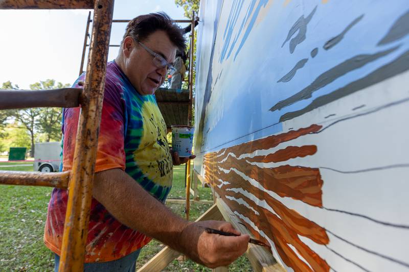 Doug Haffner of the Walldogs paints log on the Streator mural on Thursday, Sept. 11, 2025 at City Park in Streator.