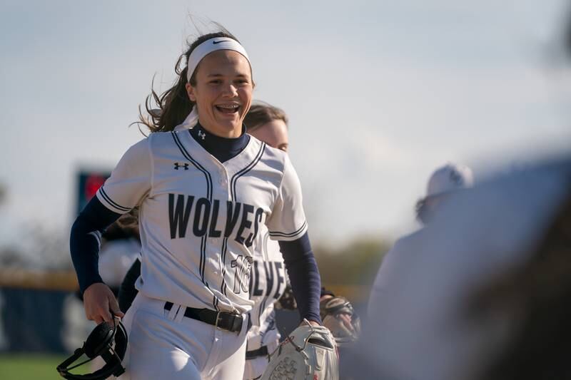 Oswego East's Nicole Stone (16) smiles after striking out an Oswego batter during a softball game at Oswego East High School on Friday, April 21, 2023.