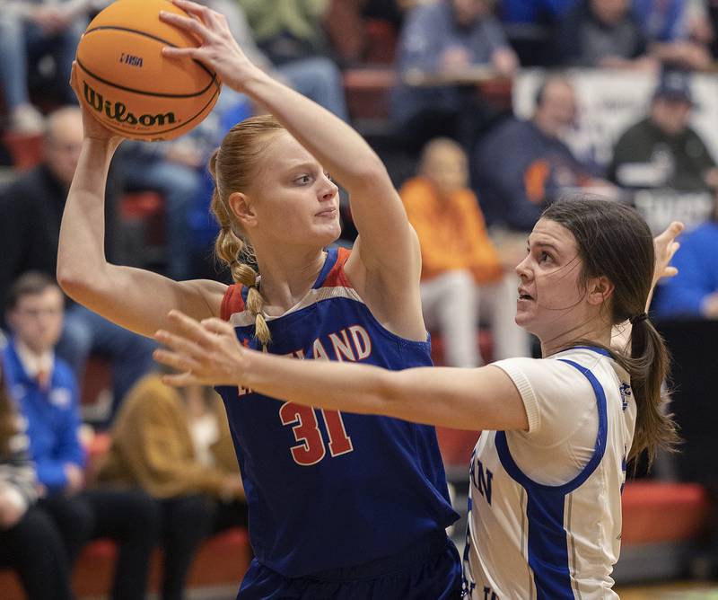 Eastland’s Violet Diehl looks to pass while being defended by Newman’s Helen Papoccia Tuesday, Feb. 18, 2025, during the Class 1A girls basketball regional at Forreston.