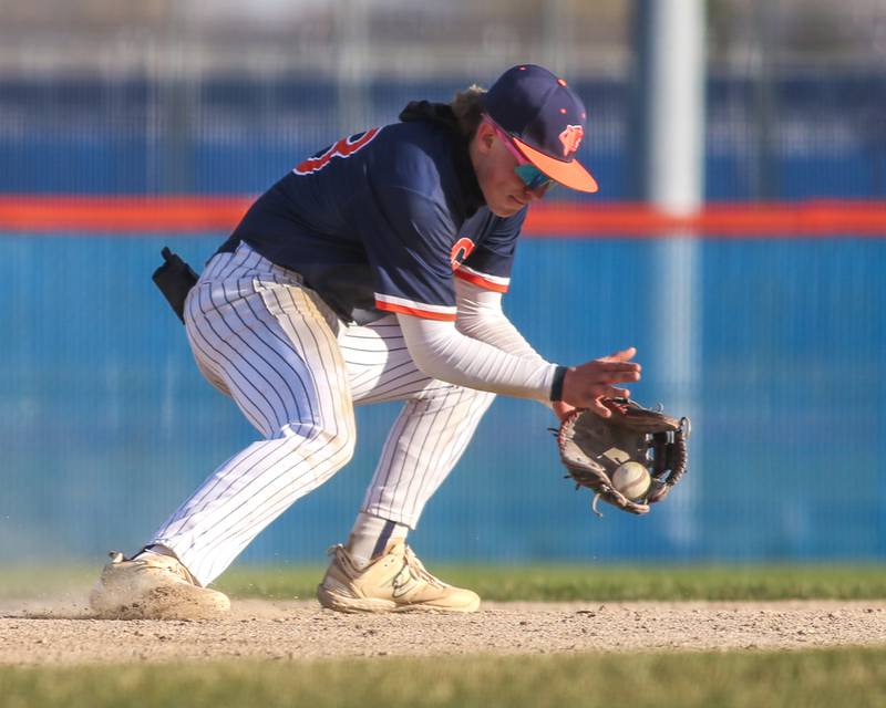 Oswego's Conor Tully (23) snags a ground ball during baseball game between Plainfield South at Oswego on Monday, April 14, 2025 in Oswego.