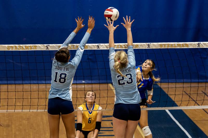 Joliet Central's Alivea Gonzalez goes for a kill as Plainfield South's Abby Abrokwa and Grace Malek attempt to block during a varsity volleyball game at Joliet Central on Sept. 18, 2025.