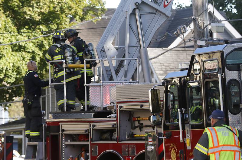 Firefighters battle a house fire in the 300 block of Lincoln Avenue in Woodstock Monday, Oct. 9, 2023, after an explosion following suspected gas leak in the area.