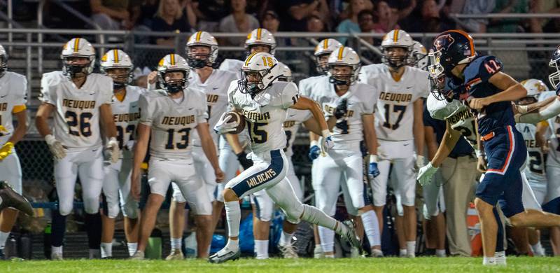 Neuqua Valley's Carter Stare (15) returns a punt for a touchdown against Oswego during a football game at Oswego High School on Friday, Aug 26, 2022.