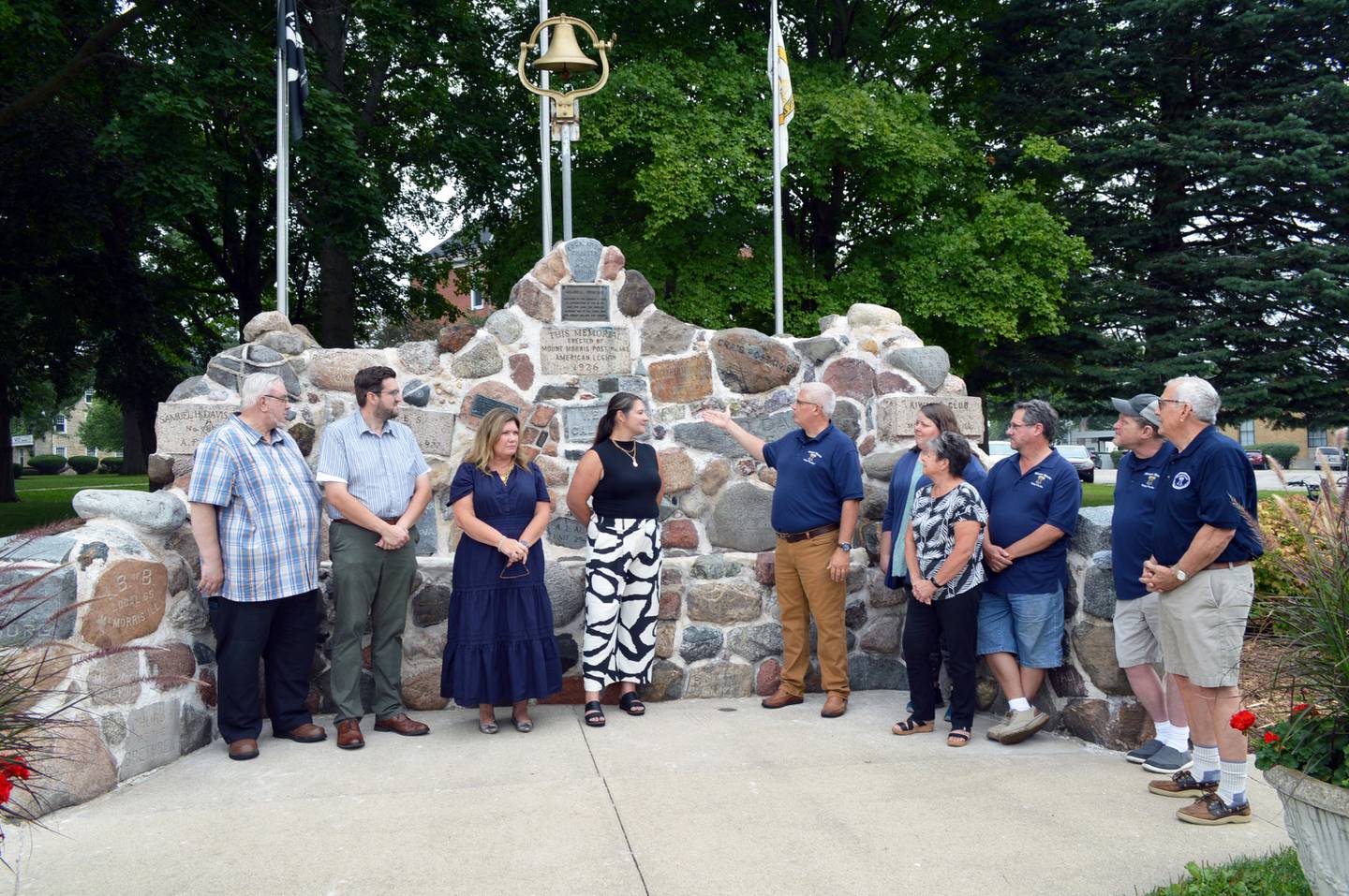 A dedication of the recently restored Veterans Memorial Fountain, originally built in 1926, took place Thursday, Aug. 29, 2024, in downtown Mt. Morris. Left to right are: Heritage Restoration & Design Studio President Michael Berlinger; Heritage Chief Operating Officer Stephen Berlinger; Kohler Foundation senior manager of art preservation Liesl Testwuide; Kohler Foundation Preservation Project Manager Beth Wiza; Mt. Morris Village President Phil Labash; Mt. Morris Trustee Melissa Rojas; Mt. Morris Economic Development Corporation Executive Director Paula Diehl; village Trustee Morgan McConnell; village Trustee Chris Kolling; and EDC Chairperson Rob Urish.