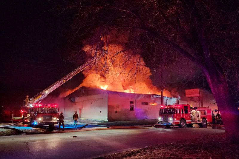 Flames emerge from the Gilster-Mary Lee factory in Momence on Tuesday, Feb. 11, evening as firefighters work to contain and extinguish the blaze. Momence Fire Chief Jim Spoon estimated damages reached between $10 - $15 million.