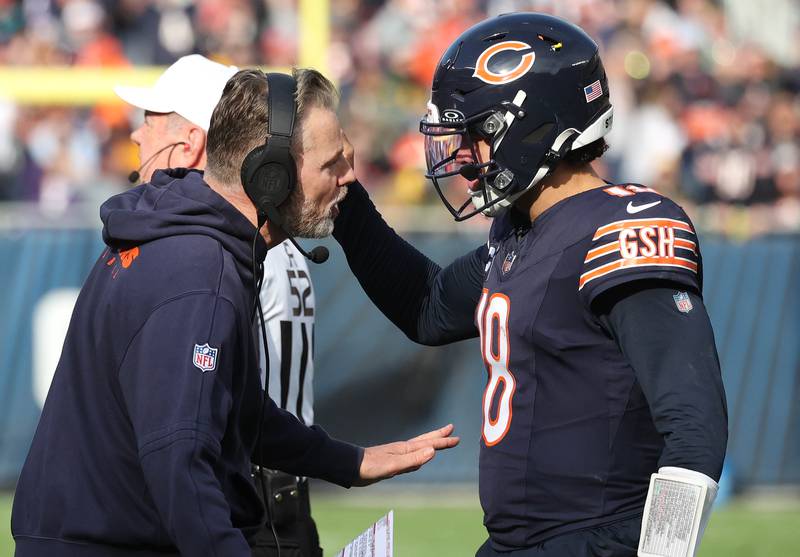 Chicago Bears Head Coach Matt Eberflus talks to quarterback Caleb Williams Sunday, Nov. 17, 2024, during their game against the Green Bay Packers at Soldier Field in Chicago.
