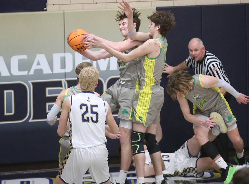 Seneca's Brady Sheedy grabs a rebound over Marquette's Luke McCulough on Friday, Feb. 21, 2025 in Bader Gym at Marquette Academy.