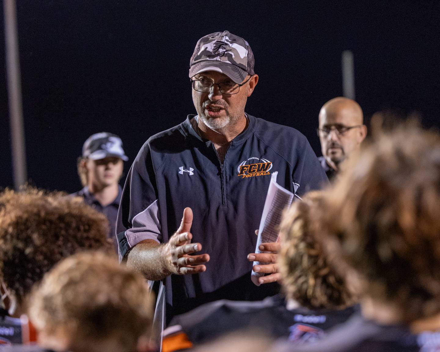 FCW head coach Todd Reed talks with his team after the Falcons' win Friday, Sept. 26, 2025, at Woodland School in rural Streator.