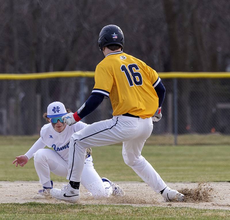 Newman’s Garret Matznick drops a throw so is unable to tag out Sterling’s Garrett Polson on a steal Tuesday, March 12, 2024.