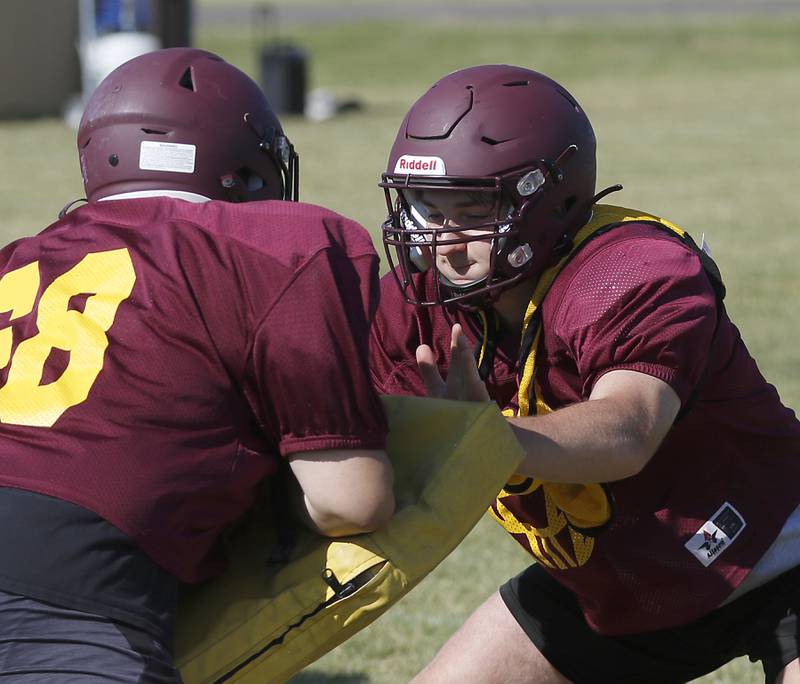 Richmond-Burton’s Steven Siegel, right fights through a block during summer football practice Thursday, July 14, 2022, at Richmond-Burton High School in Richmond.