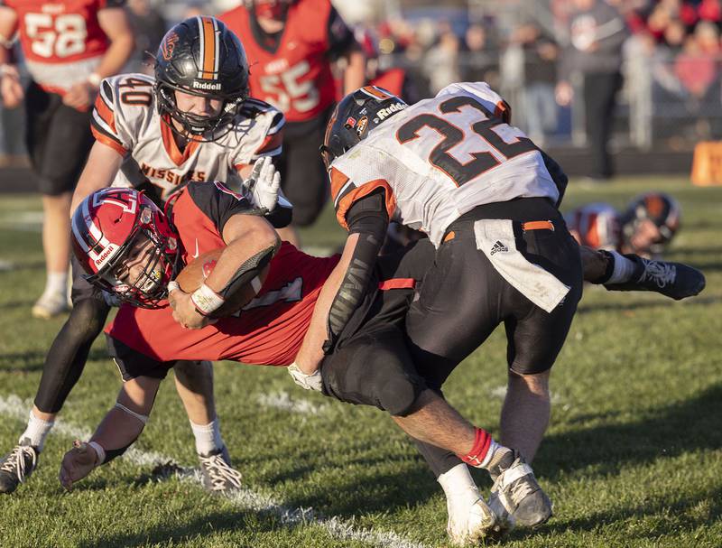 Amboy’s Jose Lopez is taken down Milledgeville’s Jayden Promenschenkel Saturday, Nov. 15, 2025, in the 8-man football semifinal.