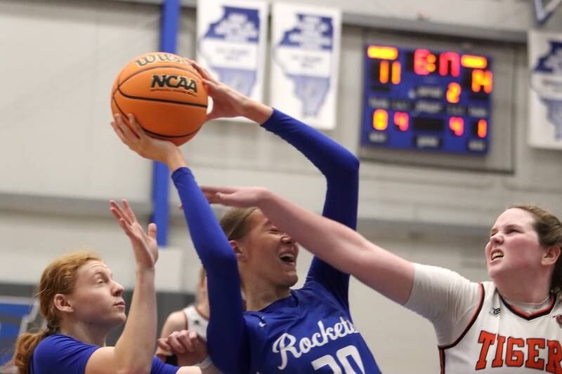 Burlington Central’s Ainsley Wilson, center, keeps the ball from Crystal Lake Central’s Leah Spychala, right, in IHSA Class 3A Regional Title Game girls basketball action on Thursday, Feb. 20, 2025, at  Central High School in Burlington.