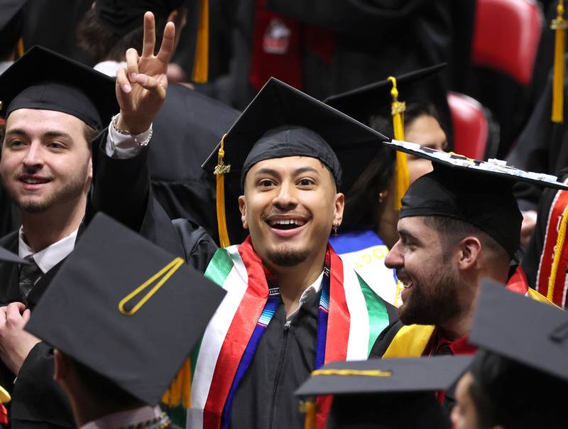 A Northern Illinois University candidate for graduation acknowledges someone in the crowd during the first of two undergraduate commencement ceremonies Saturday, May 11, 2024, in the Convocation Center at NIU in DeKalb.