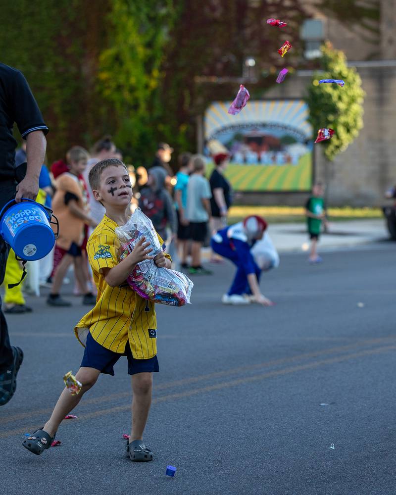 Parader tosses candy to children at the annual Princeton Halloween Parade on Saturday, Oct. 4, 2025 on Main Street in Princeton.