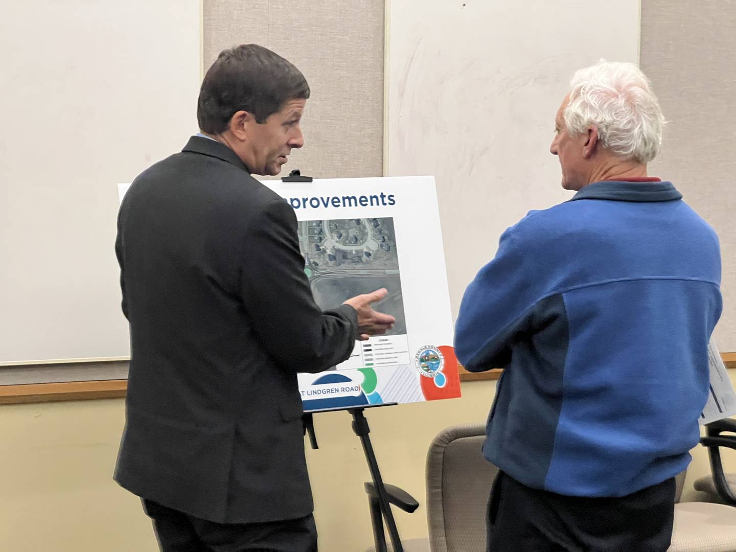 DeKalb County Engineer Nathan Schwartz talks with county resident Bill Vassilogambros during a public meeting on Nov. 14, 2024 about a proposed roundabout at the intersection of Plank and Lindgren roads.