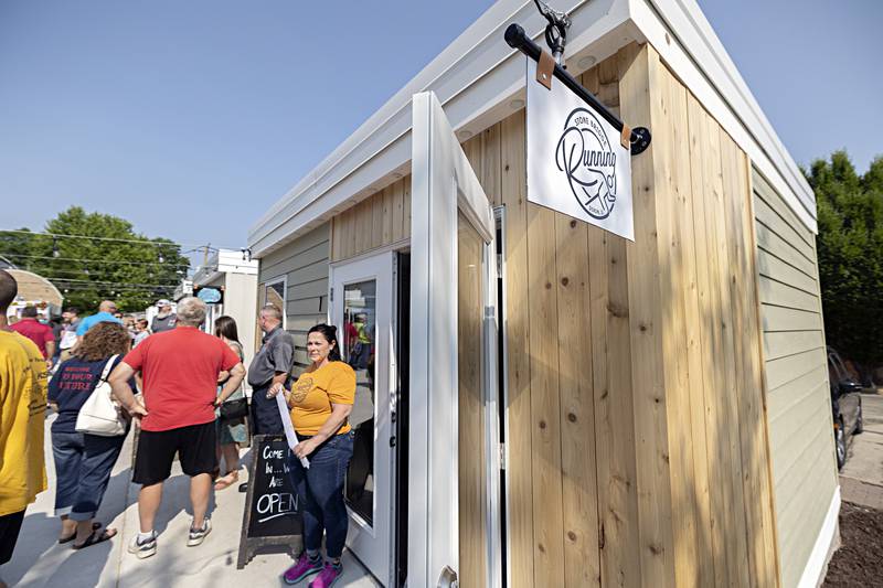 Grace Johnson, owner of Stone Bridge Running stand outside of her chalet Tuesday, June 6, 2023 after the ribbon cutting of Shoppes at Grandon.