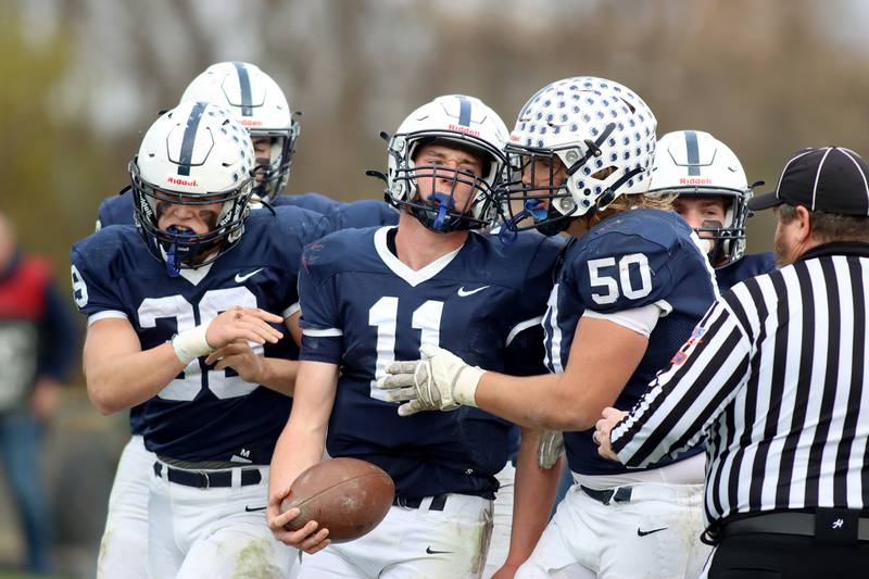 Cary-Grove’s Peyton Seaburg, center, is greeted in the end zone by Ty Drayton, right, after a touchdown against Belvidere North in IHSA Class 6A quarterfinal playoff football action on Saturday, Nov. 16, 2024, at Al Bohrer Field on the campus of Cary-Grove High School in Cary.