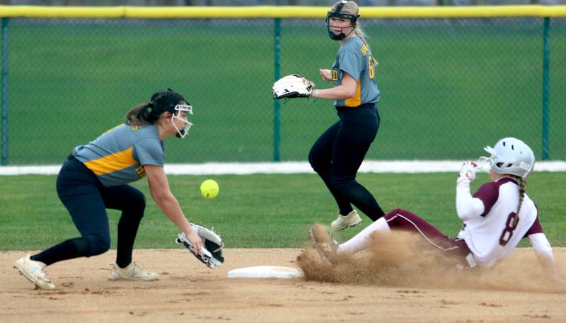 Marengo’s Gabby Gieseke, right, slides safely with a steal of second base as Harvard’s Ytzel Lopez, left, fields the throw and Manhatyn Brincks, back, follows the action in varsity softball at Marengo Thursday.