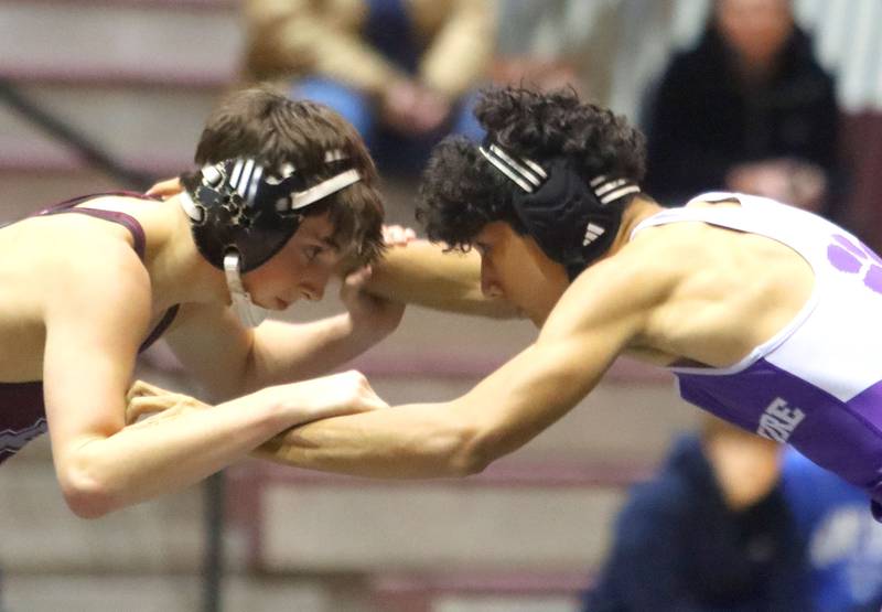Prairie Ridge’s Lorenzo Massart, left, battles Hampshire’s Gabe Calderon at 132 pounds in varsity boys wrestling on Thursday, Dec. 4, 2025, at  Prairie Ridge High School in Crystal Lake.