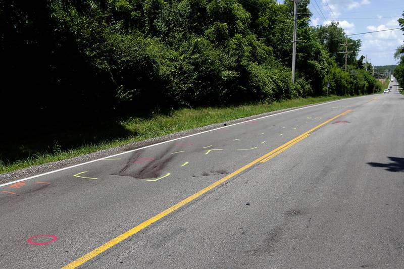 Markings from a police investigation remain on a roadway on July 3, 2025, near Crystal Lake where a 15-year-old boy was fatally hit by a car the night before. Police said the driver fled the scene.