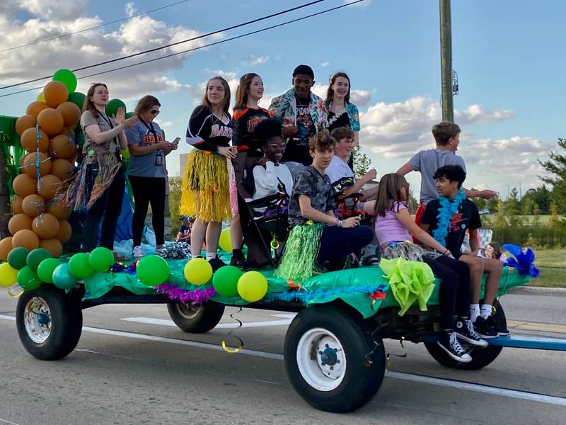 Students in the Class of 2029 wave from an island-themed float during the annual DeKalb High School Homecoming Parade on Wednesday, Sept. 24, 2025, along West Dresser Road.