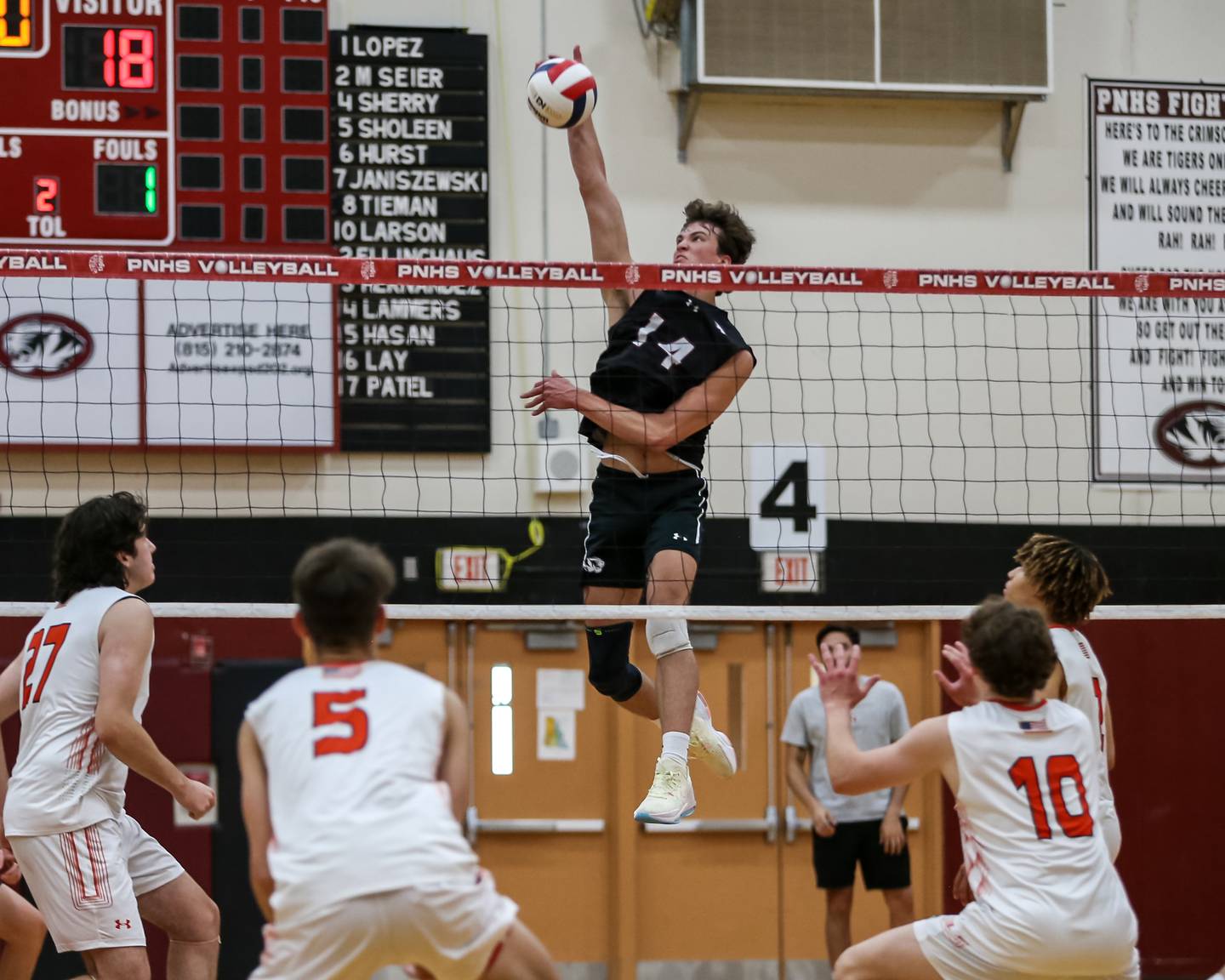 Plainfield North's Aiden Cupps (14) spikes the ball during volleyballl match between Plainfield East at Plainfield North.  May 18, 2023.