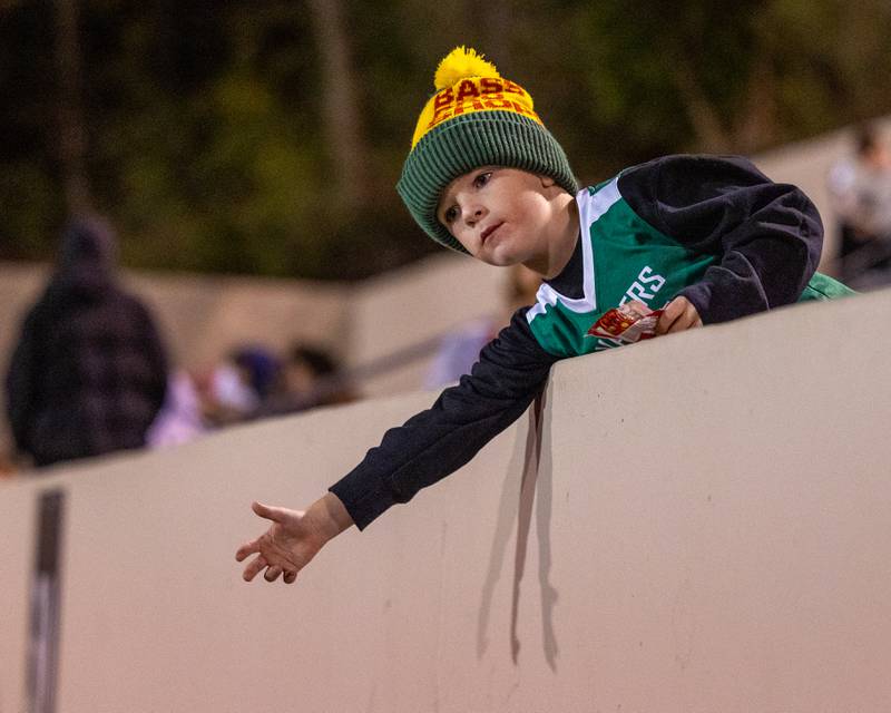 Child sticks hand over railing looking for high-five on Friday, October 24, 2025 at Howard Fellows Stadium in LaSalle.