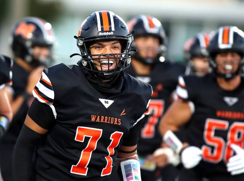 McHenry’s Jonathan Wiseman and the Warriors get revved up as they build a first-half lead against Crystal Lake South in varsity boys football at McCracken Field on the campus of McHenry High School in McHenry on Friday, Sept. 5, 2025.