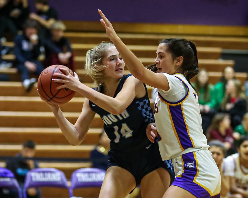 Downers Grove North's Campbell Thulin (5) defends Downers Grove South's Allison Jarvis (14) during girls basketball game between Downers Grove South at Downers Grove North. Dec 16, 2023.