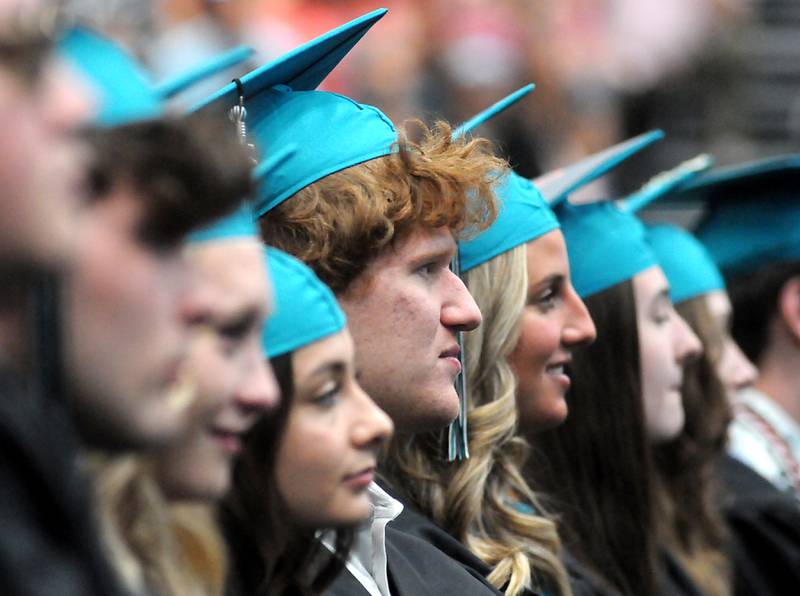 Graduates listen to a speaker Saturday, May 14, 2022, during the graduation ceremony at Woodstock North High School.
