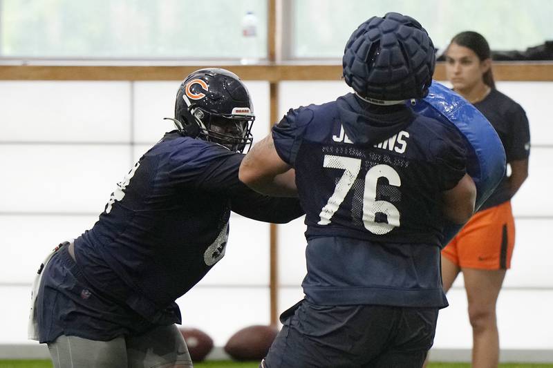 Chicago Bears offensive lineman Nate Davis, left, works with offensive lineman Teven Jenkins during NFL football practice in Lake Forest, Ill., Tuesday, June 13, 2023.