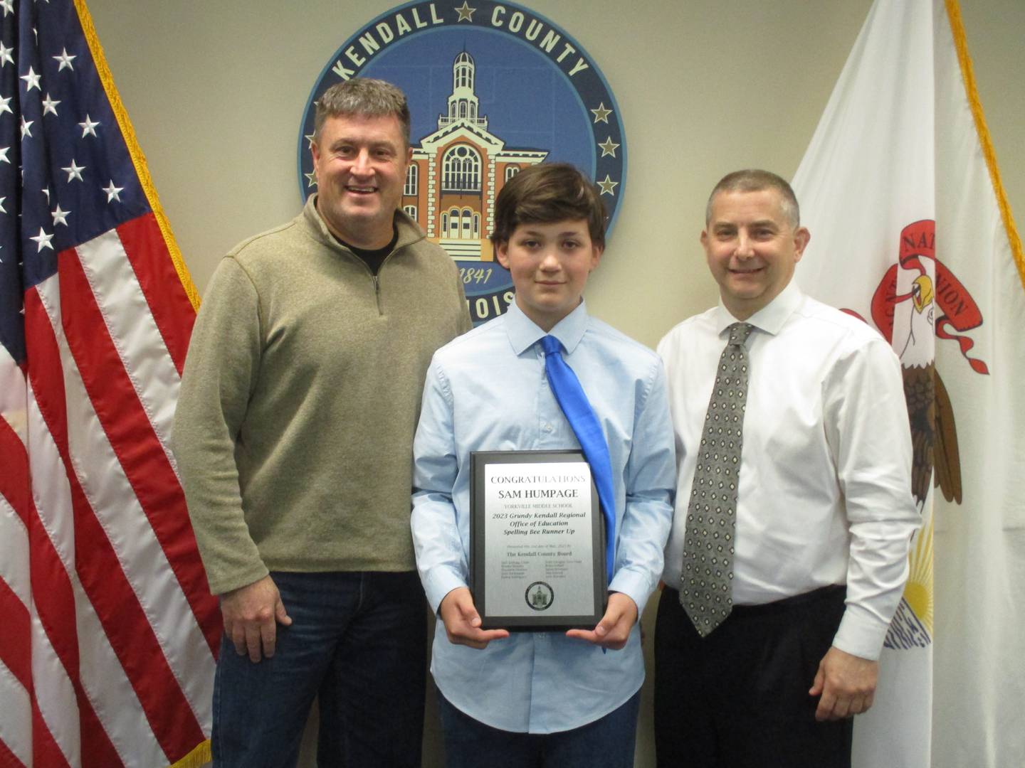 Yorkville Middle School seventh-grader Sam Humpage was the runner-up in a regional spelling bee. He is seen here on May 2, 2023 with Kendall County Board Chairman Matt Kellogg, left, and Grundy-Kendall Regional School Superintendent Chris Mehochko.