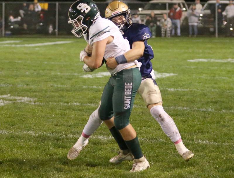 Marquette's Jaxsen Higgins brings down St. Bede's Halden Hueneburg from behind on Friday, Oct. 13, 2023 at Gould Stadium.