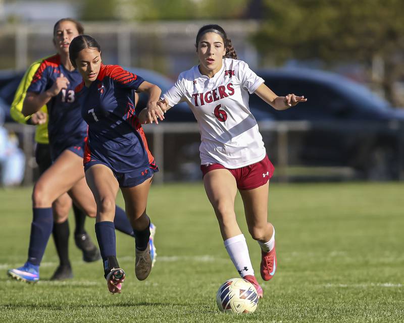 Oswego's Alexandra Ibarra (7) chases Plainfield North's Katelyn Haiser (6) during a soccer match between Plainfield North at Oswego on Monday, May 11, 2026 in Oswego.