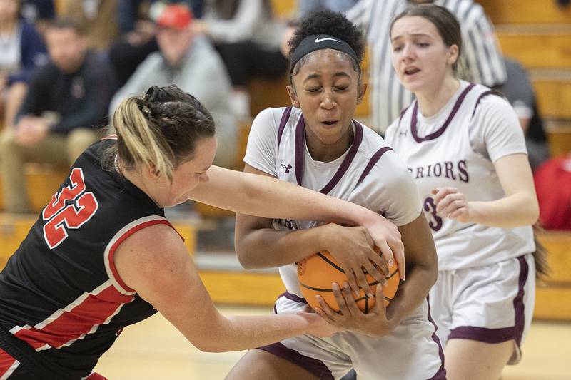 Amboy’s Emily Sachs fights for the ball with Morgan Park Academy’s Logan Lomax Tuesday, Feb. 25, 2025, in the Class 1A Sectional semifinal at Hinckley-Big Rock.