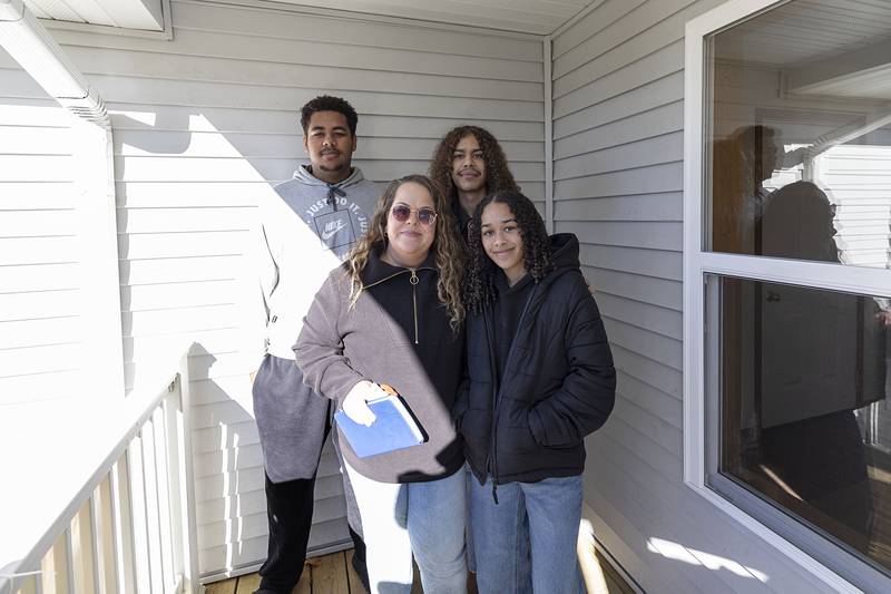 Homeowner Nichole Richardt with her sons Isaiah Chattic (back left) and Devrin Thomas and daughter Azareya Chattic are shown after their Habitat for Humanity house blessing Sunday, Nov. 23, 2025, in Dixon. Richardt will “still be living out of boxes,” come Thanksgiving, but is in charge of hosting Christmas this year.