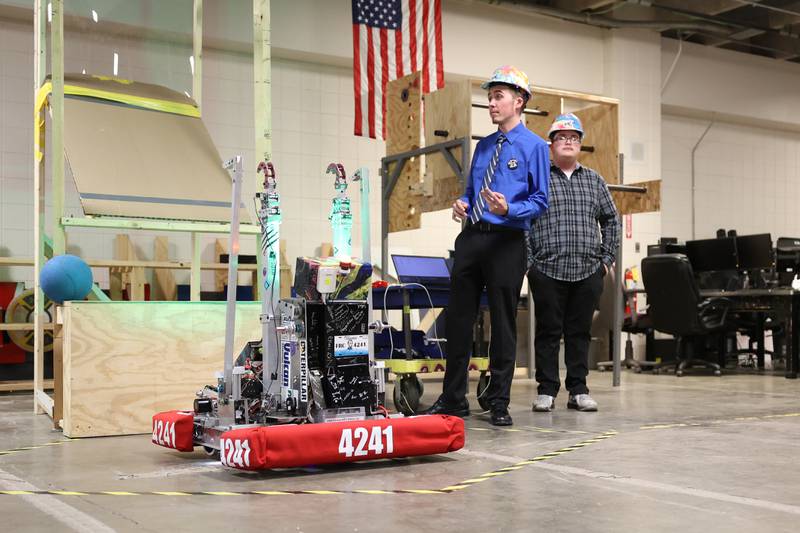 Steel Tigers Robotics Team 4241 team members Matthew Papesh, left, and Aidan Morales talk about their robot at the unveiling for the upcoming FIRST Robotics Midwest Regional Competition. Wednesday, April 6, 2022, in Joliet.