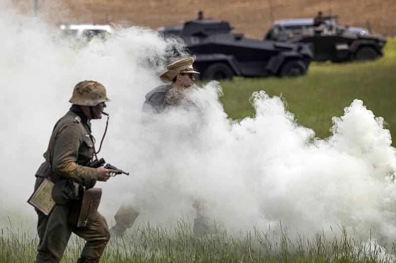 Smoke is used to cover troop movements Saturday, May 16, 2026, during a reenactment of the Battle of Anzio in Franklin Grove.